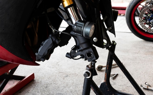 Front view motorcycle up to stand to remove wheel to change tire