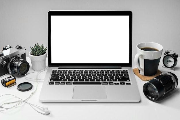 Front view of the office deks with laptop computer with blank white screen