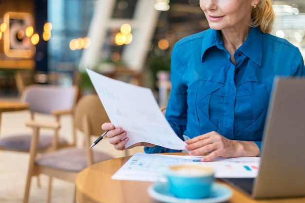 Front view of older business woman dealing with papers