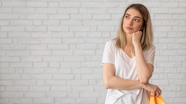 Front view of pensive woman holding cloth with copy space