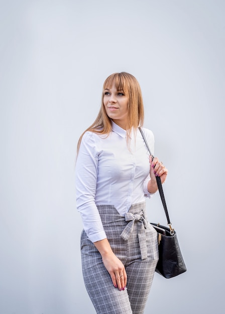 Front view portrait of a confident business woman on grey background