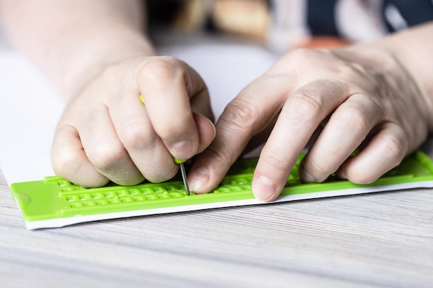 Front view of printing in braille with slate