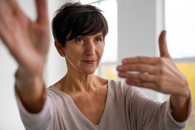 Front view senior woman practicing tai chi