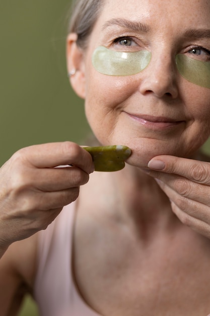 Front view senior woman with eye patches