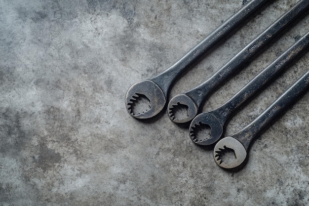 Front view of set of spanners on concrete background