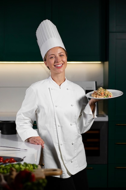 Front view smiley woman holding plate