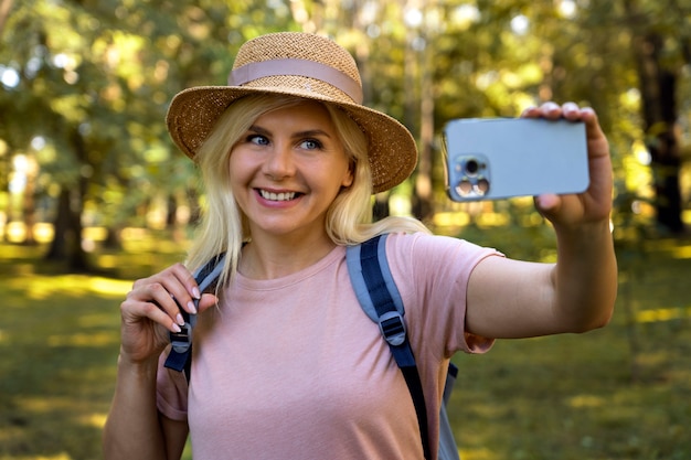 Front view smiley woman taking selfie