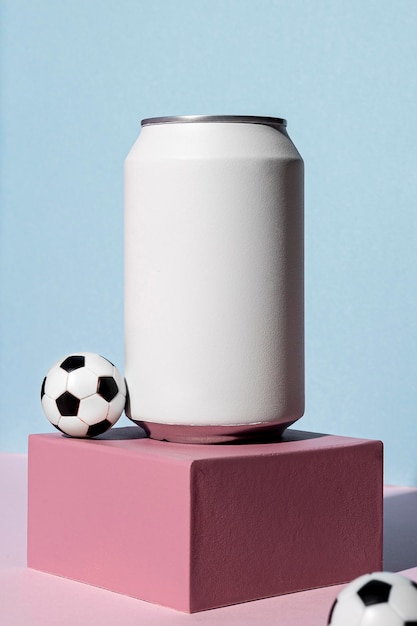 Front view of soda can with footballs