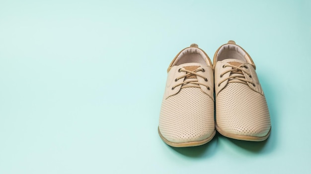 Front view of summer men's shoes on a blue background