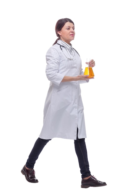 Front view of walking female scientist with beaker