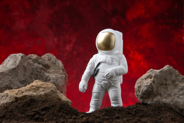 Front view of white astronaut on moon on a red  cosmic fantasy sci fi