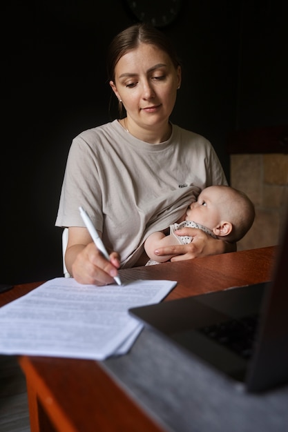 Front view woman doing chores with baby