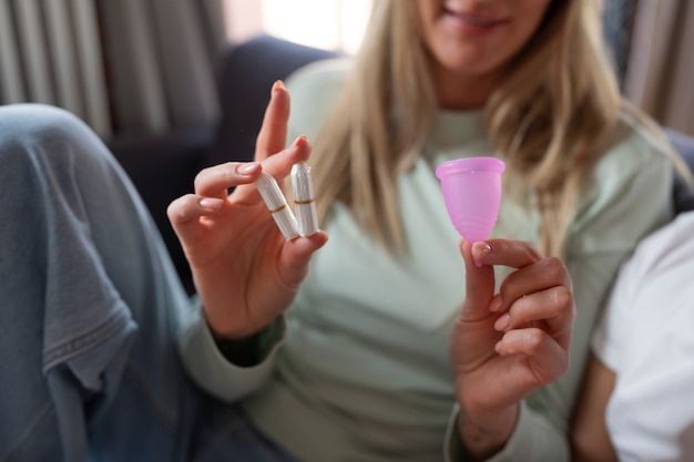 Front view woman holding menstrual products