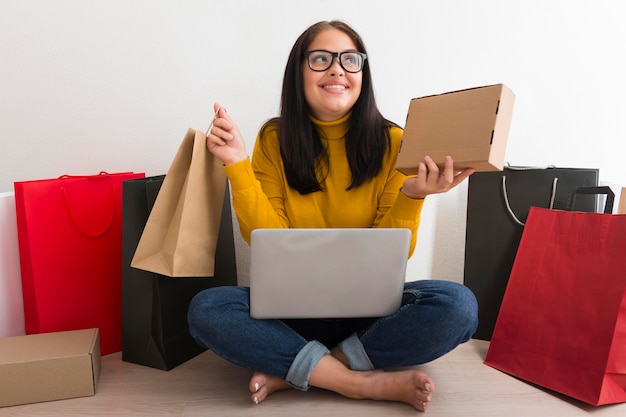 Front view woman holding new packages from cyber monday sales