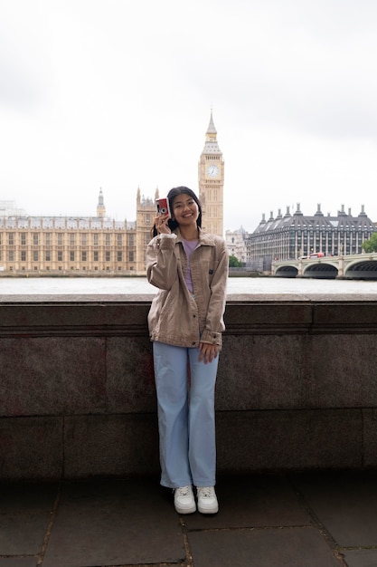 Front view woman holding photo camera