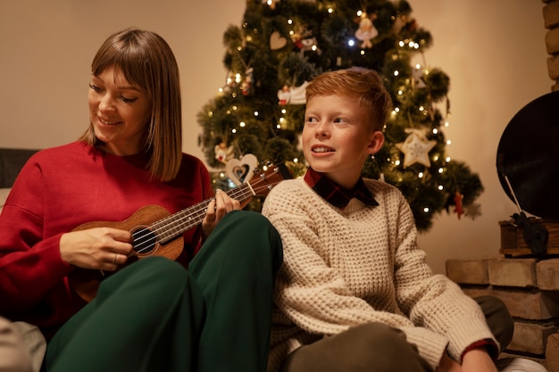 Front view woman playing the ukulele