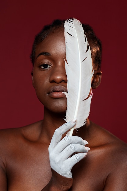 Front view woman posing with feather