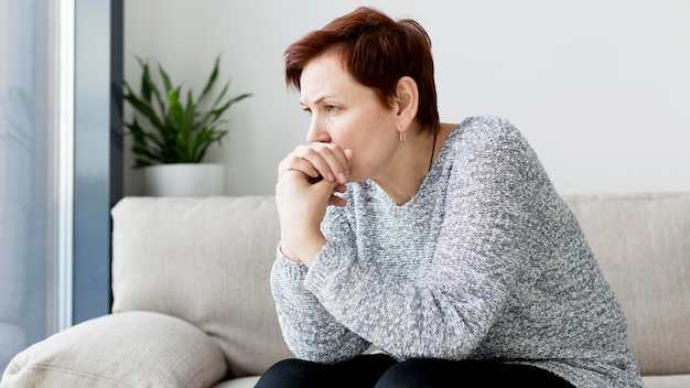 Front view of woman sitting on couch