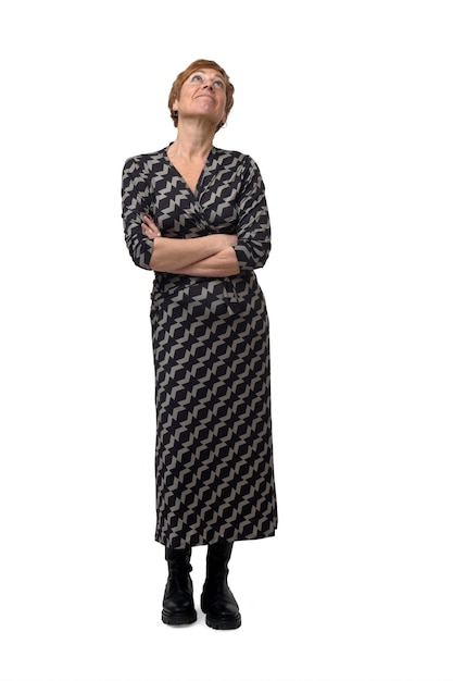 Front view of a woman with arms crossed looking up on white background