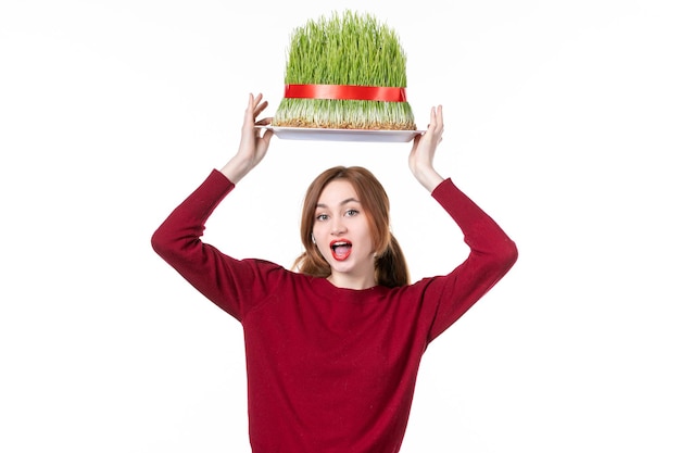 front view young female holding big green novruz semeni on her head on white background spring ethnic performer ethnicity concept colours family