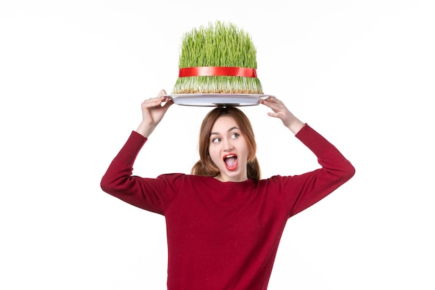 front view young female holding big green novruz semeni on white background spring ethnic performer ethnicity concept colours holidays family