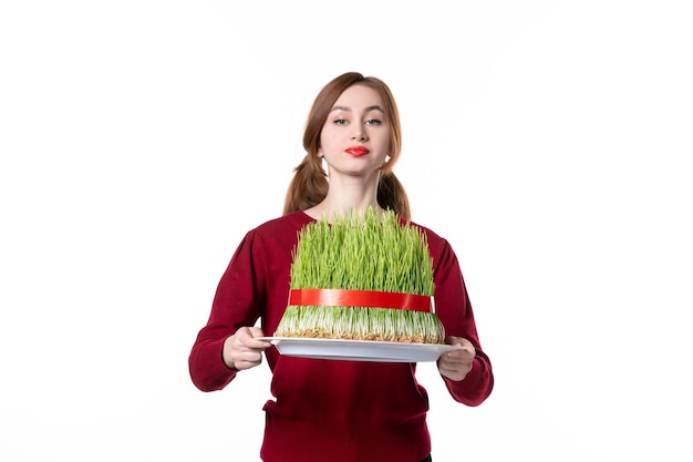 front view young female holding big green novruz semeni on white background spring ethnic performer holiday concept family colours