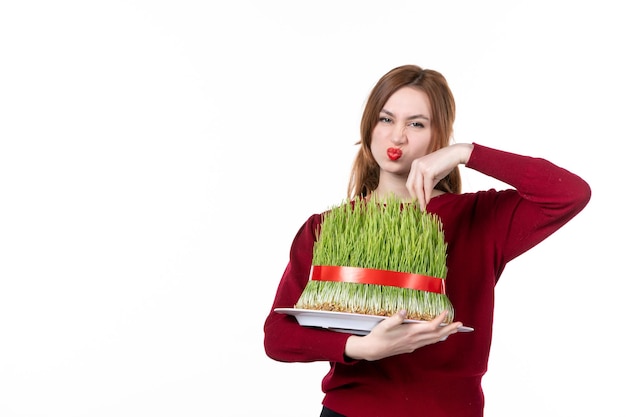 front view young female holding big novruz semeni on white background concept ethnicity family ethnic holiday spring performers colours