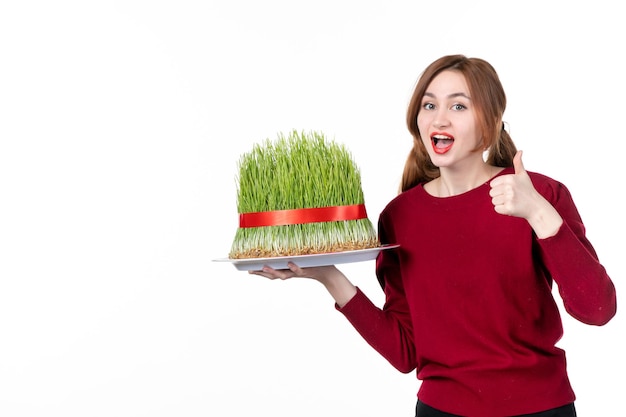 front view young female holding big novruz semeni on white background ethnicity family ethnic holiday colours concept spring performer