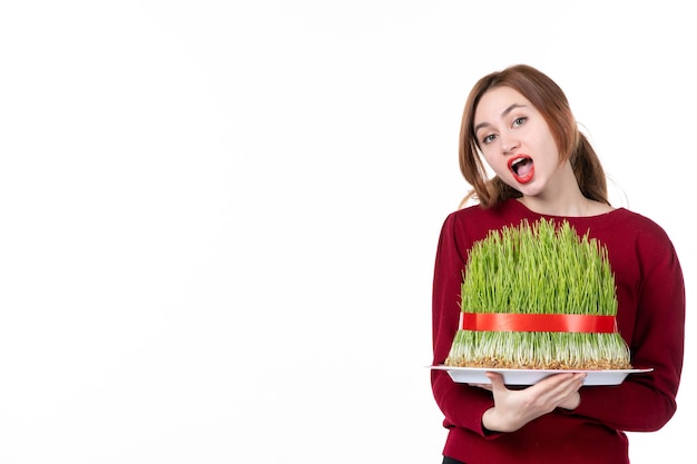 front view young female holding big novruz semeni on white background ethnicity family ethnic holiday colours concept spring performers