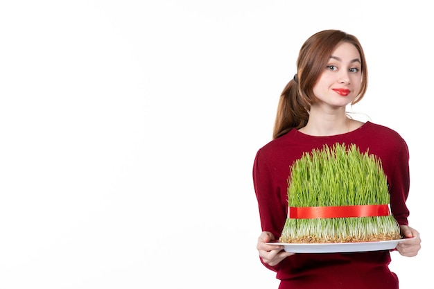 front view young female holding big novruz semeni on white background ethnicity family ethnic holiday concept performer colours