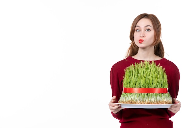 front view young female holding big novruz semeni on white background ethnicity family ethnic holiday concept spring performer colour