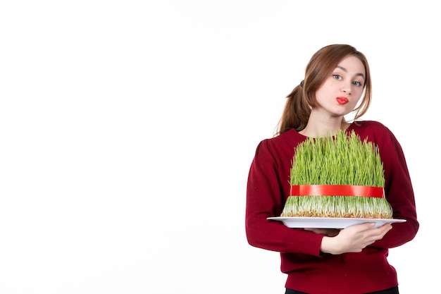 front view young female holding big novruz semeni on white background ethnicity family ethnic holidays concept spring performer colours