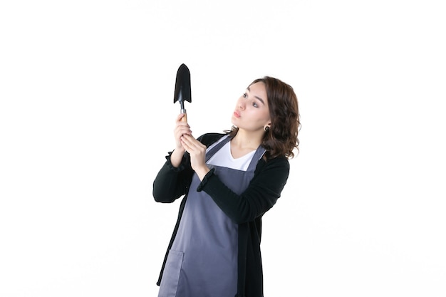 front view young female holding spatula on white background woman garden green flower uniform emotions tree