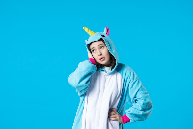 front view young female in pajama party on blue background rest sleep late fun night game bed dream color