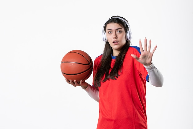 Front view young female in sport clothes with basketball