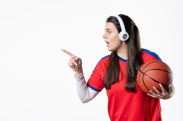 Front view young female in sport clothes with basketball