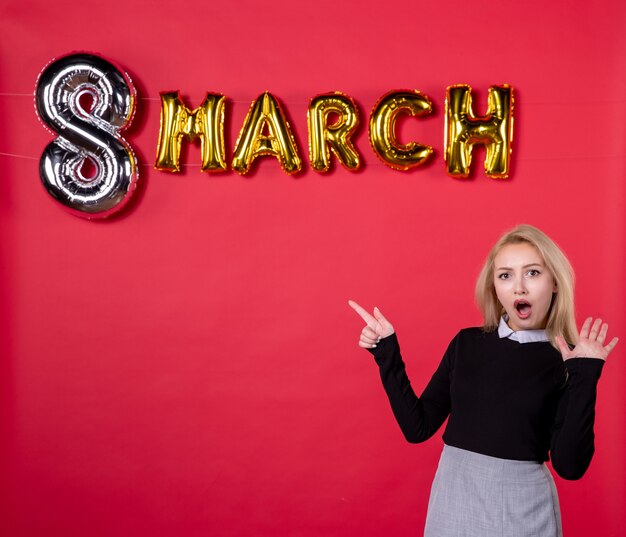 front view young female with march decoration on red background passion salon love luxurious womans day holiday equality feminine