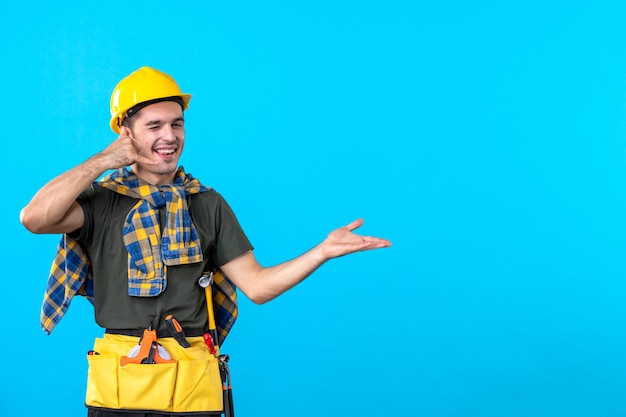 front view young male builder in yellow helmet on blue background worker tool constructor architecture flat color building