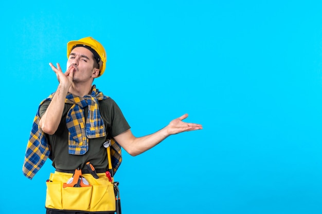 front view young male builder in yellow helmet on the blue background worker tool constructor architecture flat color building