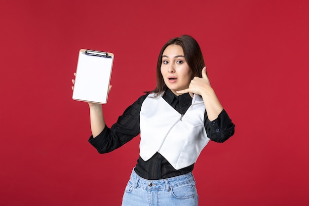 front view young pretty waitress in uniform holding file note for orders on red background beauty woman dinner work evening job food