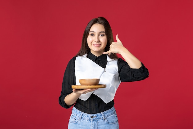 front view young waitress holding food order on red background work food job meal beauty worker evening woman color dinner uniform smile