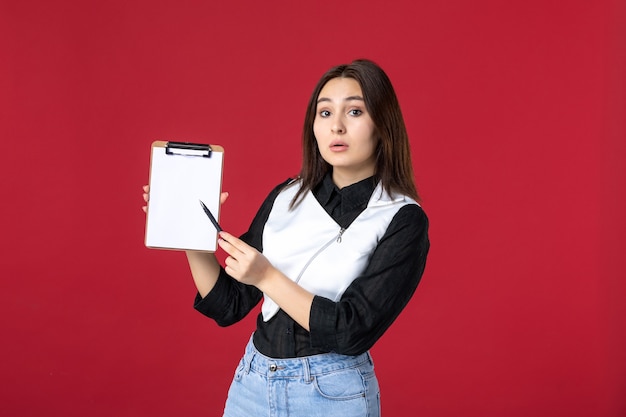 front view young waitress holding little notepad for orders on red background work food job meal beauty worker evening woman color dinner