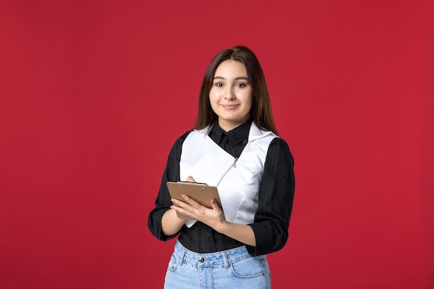 front view young waitress in uniform writing order on red background beauty woman work evening job restaurant worker