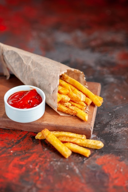 Front view yummy french fries with ketchup on cutting board dark background snack dish fast-food sandwich dinner toast burger