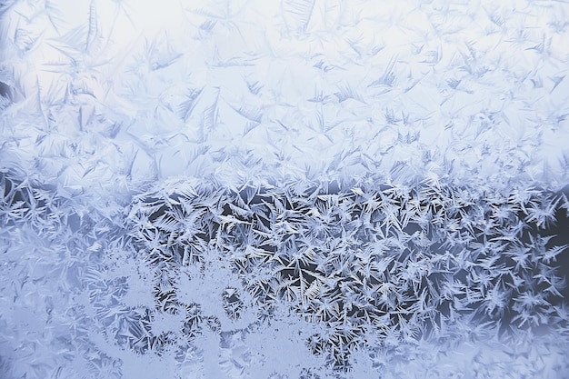 frost patterns on window glass, abstract background winter rime snow