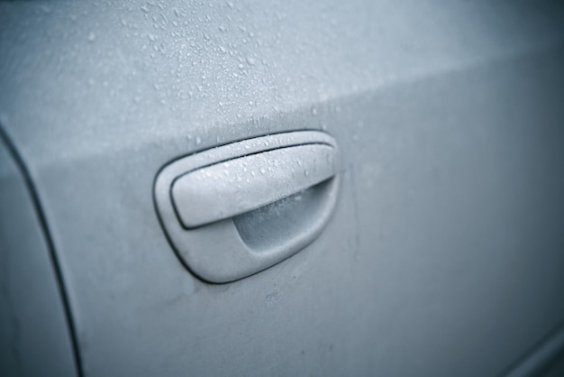 Frosted ice car door handle covered with ice crystals the iced vehicle handle Concept of a frosty morning