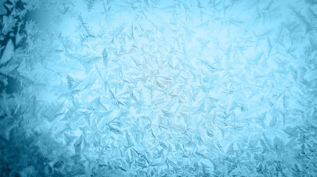 Frosty christmas pattern at a winter window glass