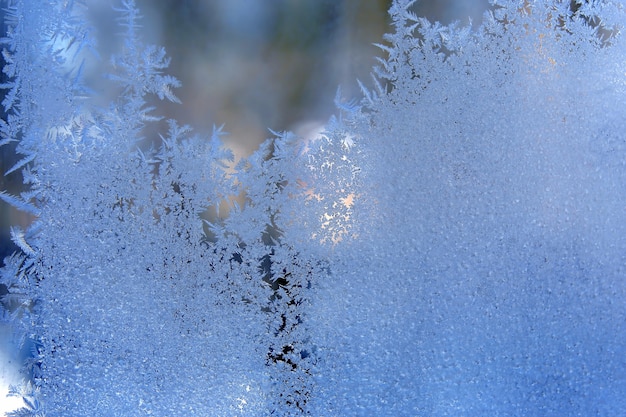 Photo frosty patterns on the window glass closeup