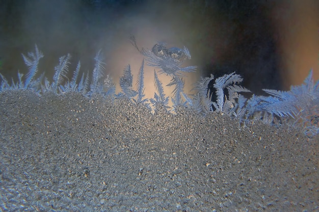 Photo frosty patterns on the window glass closeup