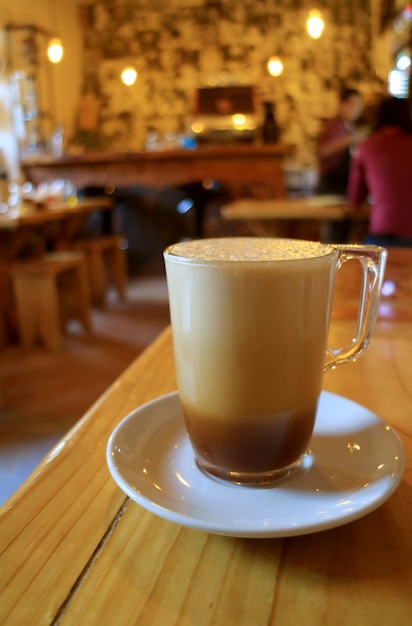 Frothy Iced Cappuccino Coffee on the Wooden Table